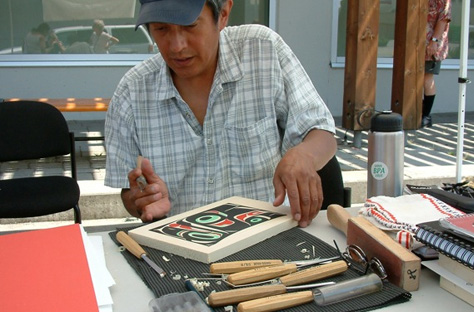 James Shorty carving his printed cedar blocks